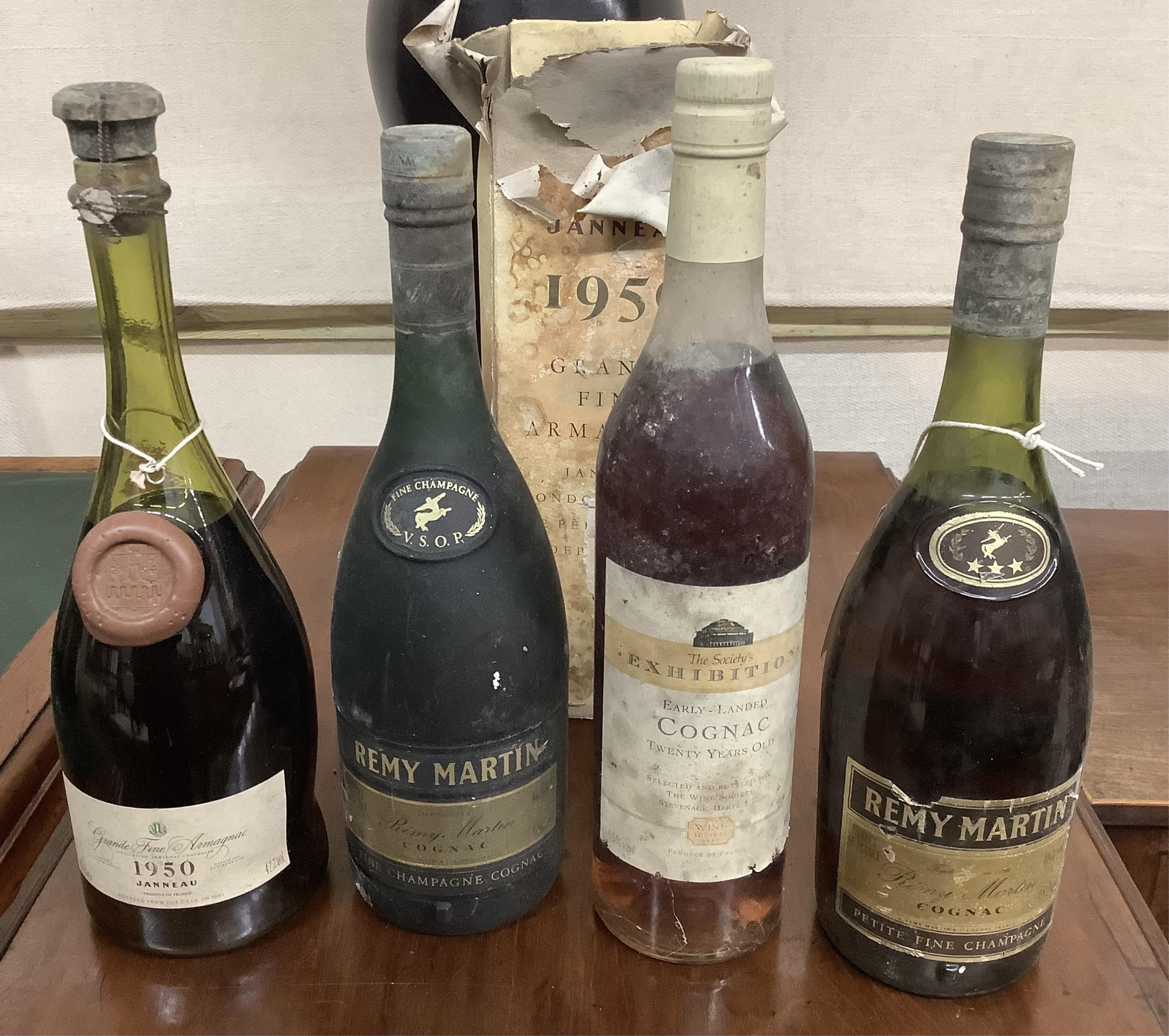 A bottle of 1950 Janneau Grande Fine Armagnac, a bottle of The Society’s Exhibition Early Landed Cognac and two bottles of Remy Martin Champagne Cognac. Condition - fair, from a local private cellar